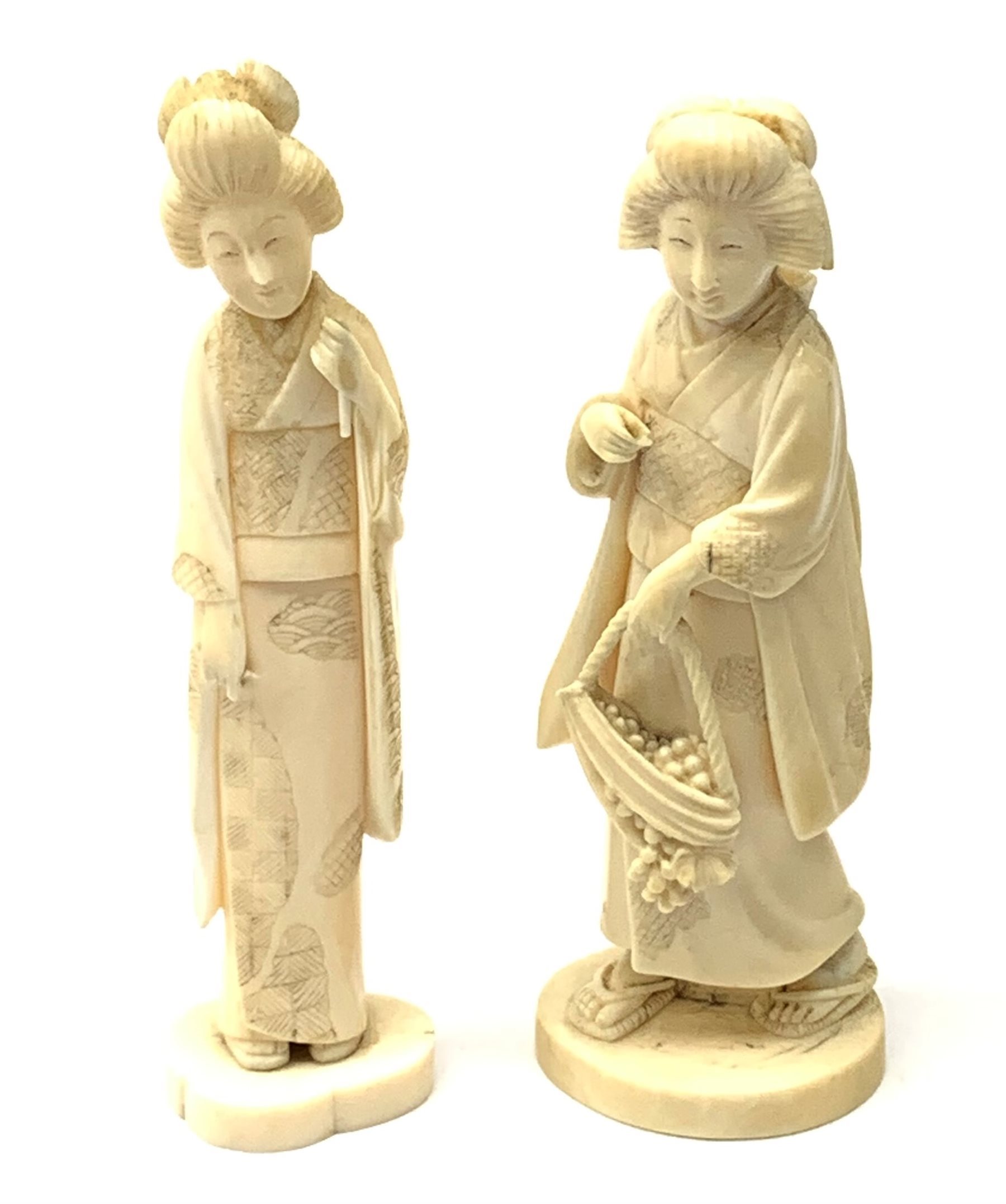 Two Japanese carved ivory okimons, each modelled as a geisha, each approximately H15cm.