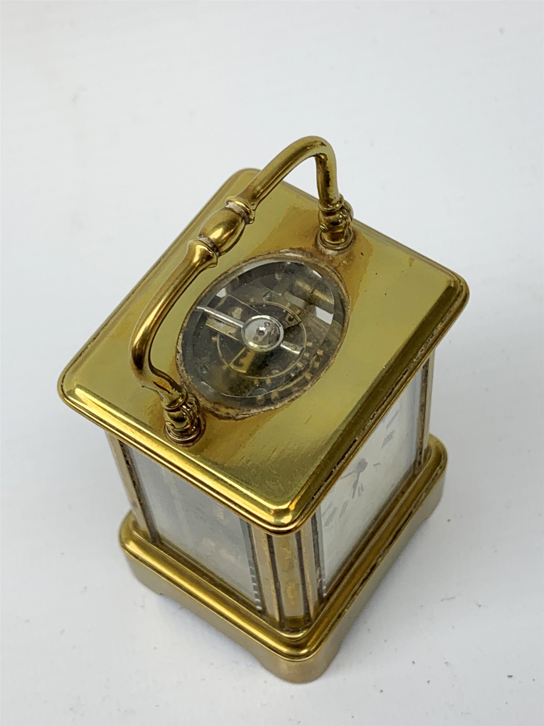 A brass cased miniature carriage clock, the white enamel dial with black Roman numerals, H7cm. - Image 3 of 7