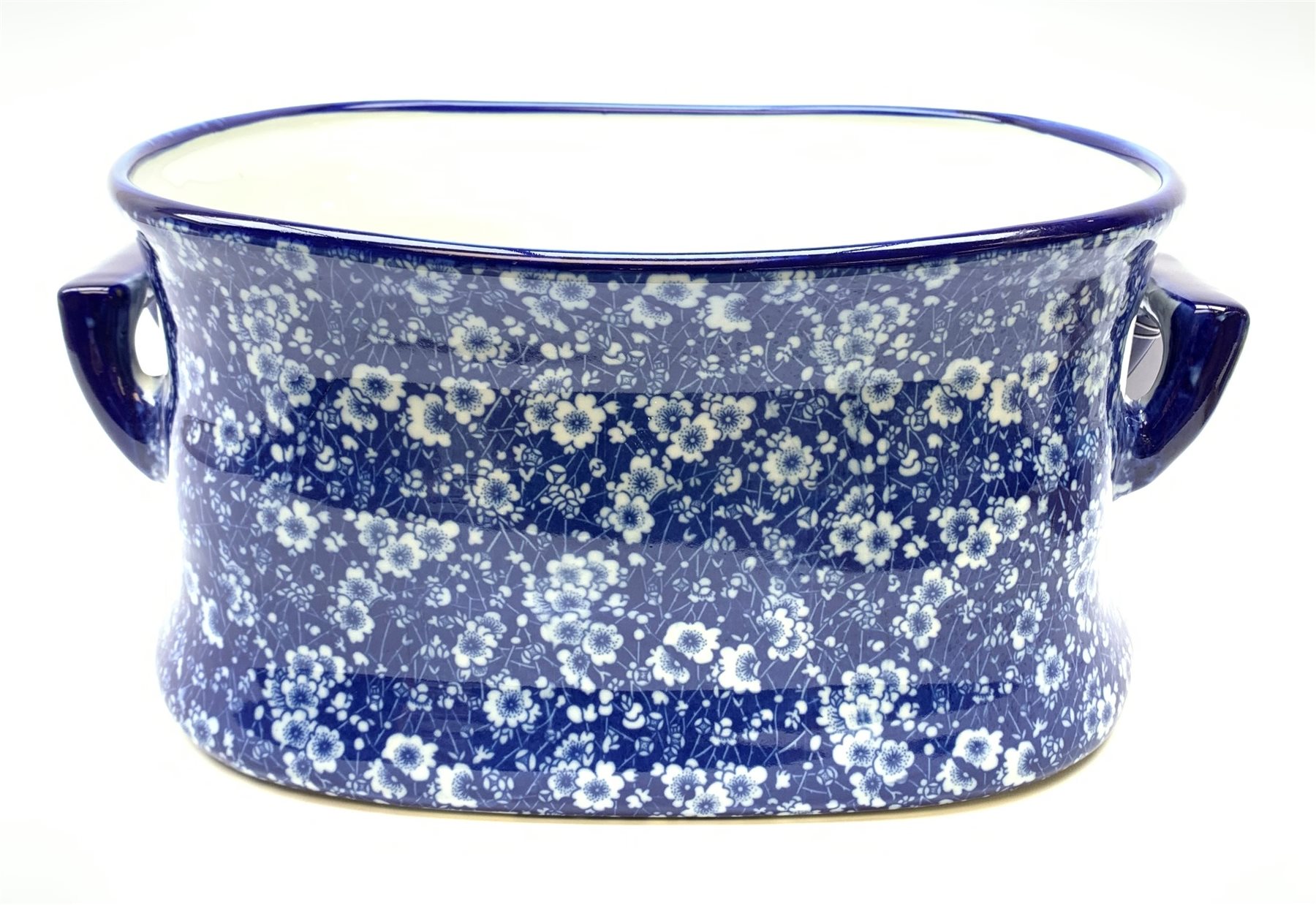 A modern blue and white transfer printed prunus blossom pattern footbath, with twin carry handles, L
