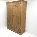 Solid pine double wardrobe, projecting cornice, two doors above two drawers, plinth base, W145cm, H1