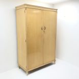 Mid 20th century maple double wardrobe, two doors enclosing fitted interior, turned reeded tapering