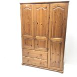 Large solid pine combination triple wardrobe, shaped moulded projecting cornice, three doors, two dr