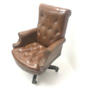 20th century captains swivel armchair, upholstered in deep buttoned studded brown leather, raised on