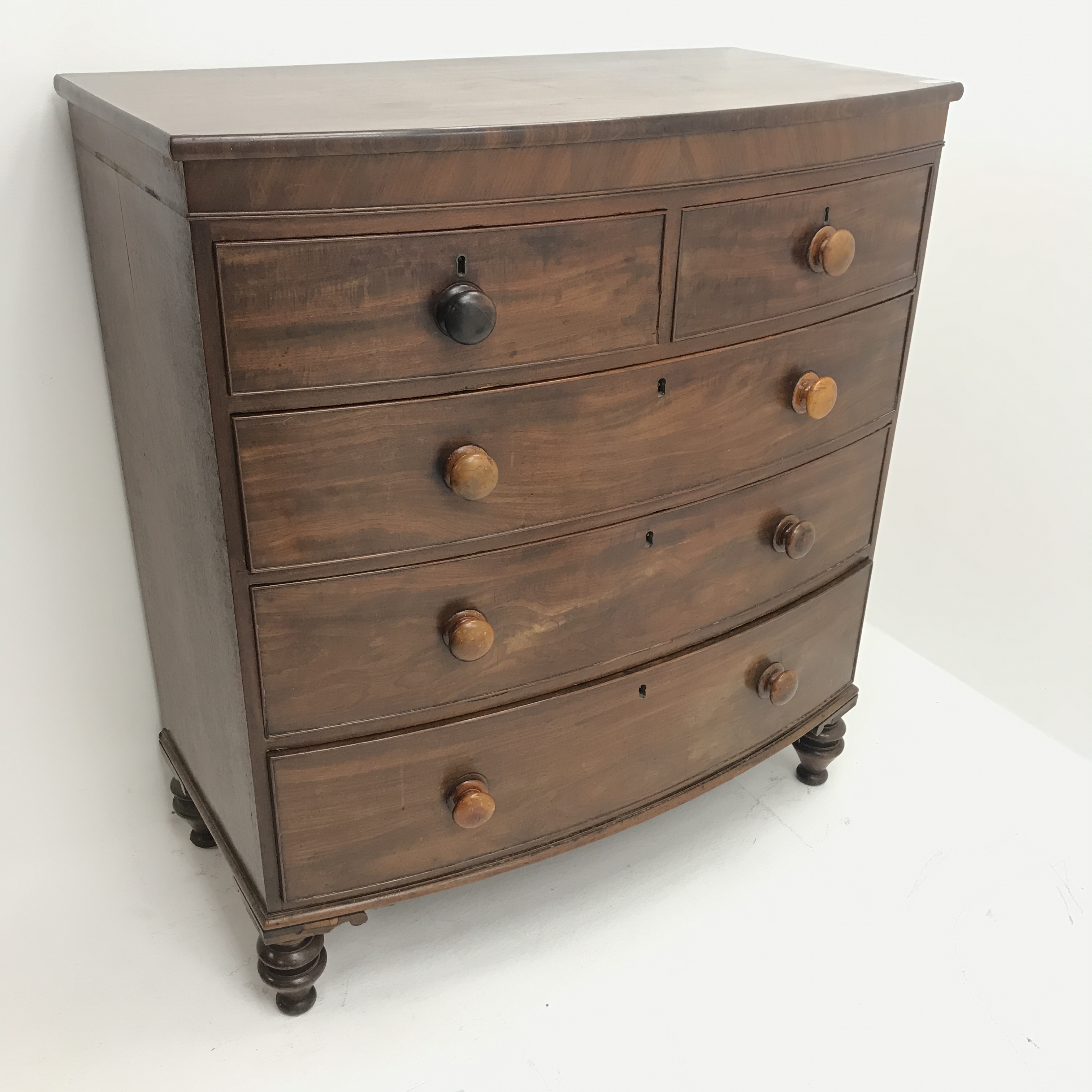 Victorian mahogany bow front chest, two short and three long drawers, turned supports, W105cm, H116c