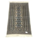 Persian style beige ground rug, repeating borer, 140cm x 87cm