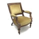 Late Victorian armchair upholstered in yellow fabric, shaped cresting rail, carved cup and cover sup