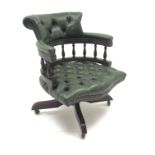 Captain's swivel chair upholstered in green buttoned leather on swivel base, W62cm