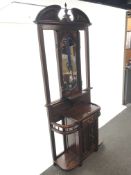 Victorian style mahogany hallstand, swan neck pediment with central finial above bevel edged mirror