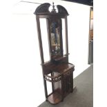 Victorian style mahogany hallstand, swan neck pediment with central finial above bevel edged mirror