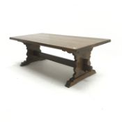 Large refectory style rectangular oak coffee table, shaped solid end supports joined by single stret