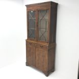 Georgian style yew wood bookcase on cupboard, two doors enclosing two shelves above two drawers and