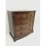 Victorian mahogany serpentine chest, two short and three long graduating drawers, bun feet, W111cm,