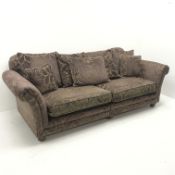 Grande three seat, two section sofa upholstered in aubergine embossed fabric, turned supports, W240c