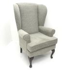 High seat wing back armchair, upholstered in a beige ground patterned fabric, cabriole legs, W73cm
