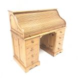 Solid pine twin pedestal shaped tambour roll top desk, fitted interior, eight drawers, shaped plinth