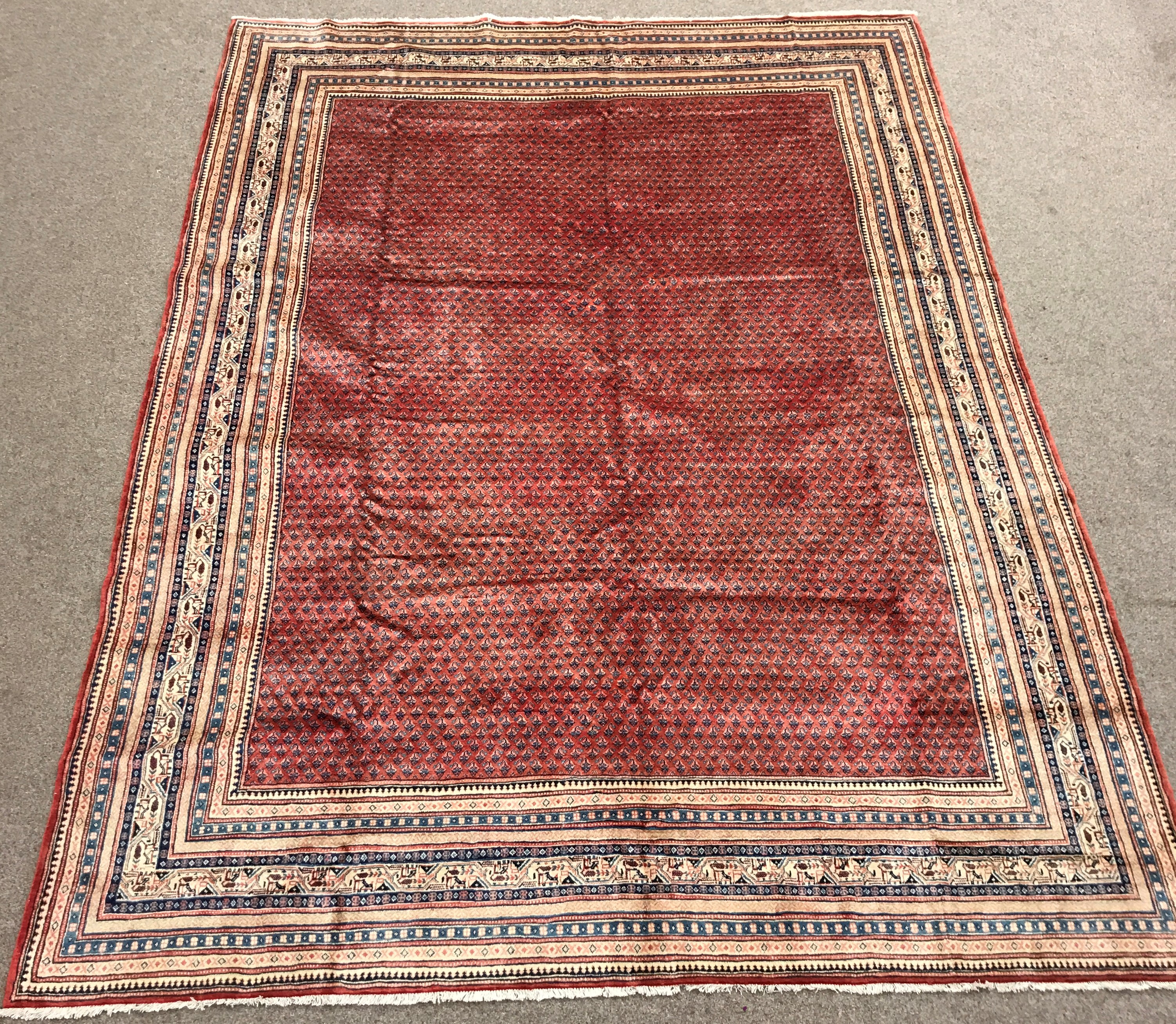 Large Persian Araak red ground rug, multiple band border, repeating boteh motifs field, 392cm x 284c