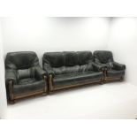 Three seat oak framed sofa upholstered in dark green leather (W180cm) and two matching armchairs (W9