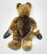 Mid-20th century plush covered teddy bear, the revolving head with applied eyes and stitched nose an