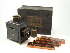 Ernst Plank magic lantern with black japanned body, brass chimney and lion paw feet, in original ebo
