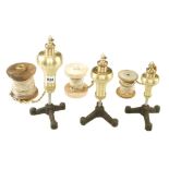 A graduated set of 3 recent steel tipped brass plumb bobs with reels on steel stands 8" to 11" F