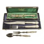 A carving knife and fork and a cake knife both on orig boxes and a pair of horn salad servers with