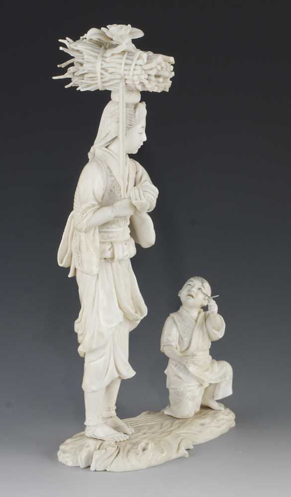 A 9" ivory okimono of a mother carrying carrying a bundle of sticks being handed a butterfly - Image 4 of 5