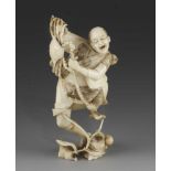 A 5" ivory okimono of a fisherman struggling to restrain a crab