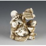 An ivory netsuke Hotoi with his children