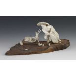 An ivory okimono of a fisherman casting his net signed KYOKUSHU on wood base 9" x 4" x 4"h.