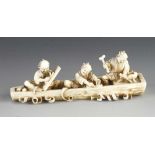 An ivory okimono of three jolly men making a boat 4" x 1 1/2"