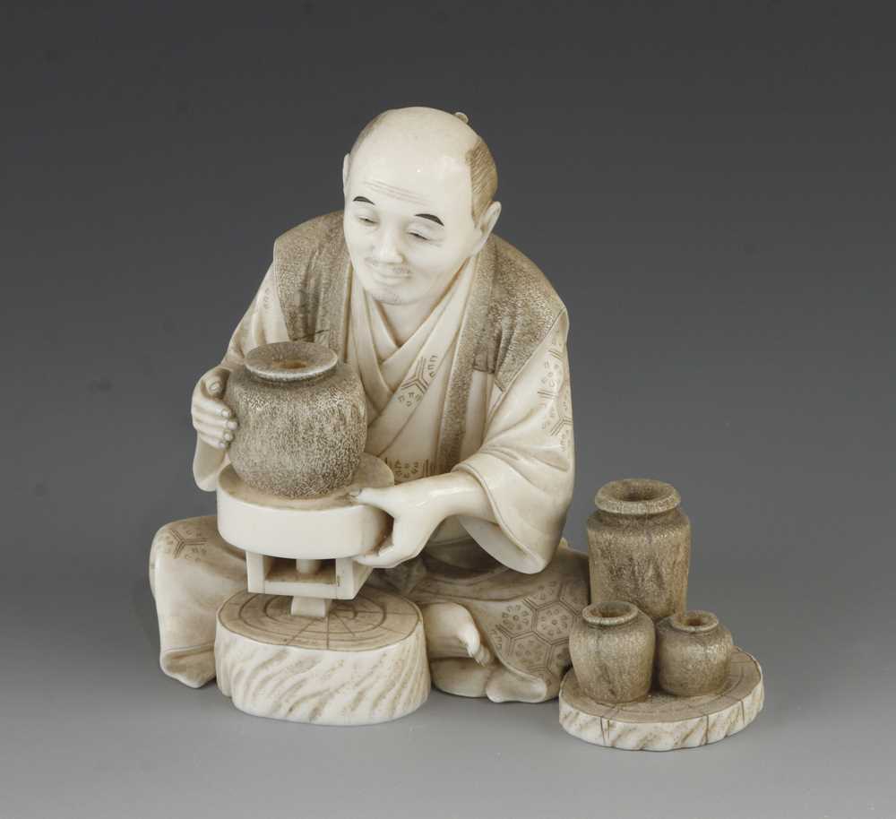 A 4" ivory okimono of a potter at his wheel