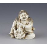 An ivory netsuke of a man with frog