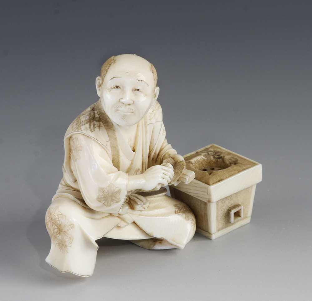 A 3" ivory okimono of a man with trowel at work