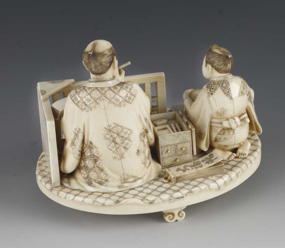 A fine ivory okimono of a draper taking notes as his apprentice measures the cloth 5" x 4" - Image 3 of 5