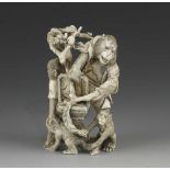 A 4" ivory okimono of a group of 4 monkeys picking fruit into a basket