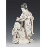 A very fine quality 8" ivory okimono of a weary merchant, his concerned wife stroking his brow,