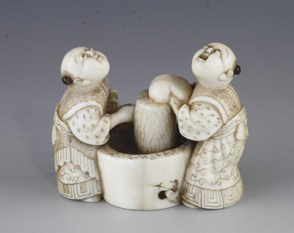 An ivory netsuke of two washerwomen