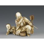 A 3" ivory okimono of a fletcher checking his arrows with his playful son