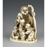 An ivory netsuke of 3 figures