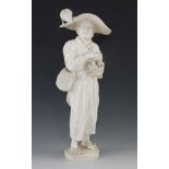 A 10" ivory okimono of a man carrying a nest with two fledglings and the concerned mother bird on
