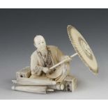 A 3" ivory okimono of a parasol maker