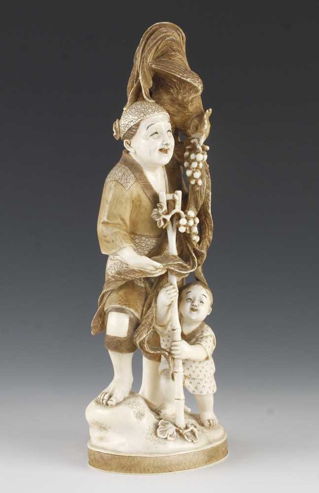 A 9" ivory okimono of a long tailed bird stealing grapes from a father and son - Image 2 of 5