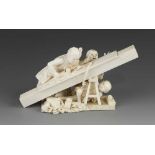An ivory okimono of a carpenter planing timber with his children getting under his feet 6" x 3"