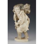 A 6" ivory okimono of a man having difficulties carrying a captured bear