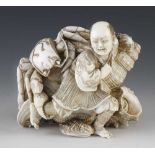 A very fine quality 4" ivory okimono of a man struggling to carry home a live crab which is gripping