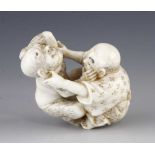 An ivory netsuke of two wrestlers