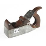 An iron smoother with closed mahogany handle and scrolled wedge behind lugs cast into the plane G+