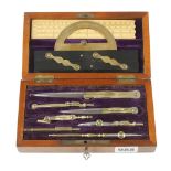 An unusually fine quality school drawing set, as illustrated, in fitted figured mahogany box with