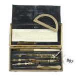 A small, early brass drawing set with early style decorative finials and with later ivory scale rule