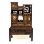 A Japanese carved wood shodana, 19th century, with an array of doors, shelves and drawers, ivory and